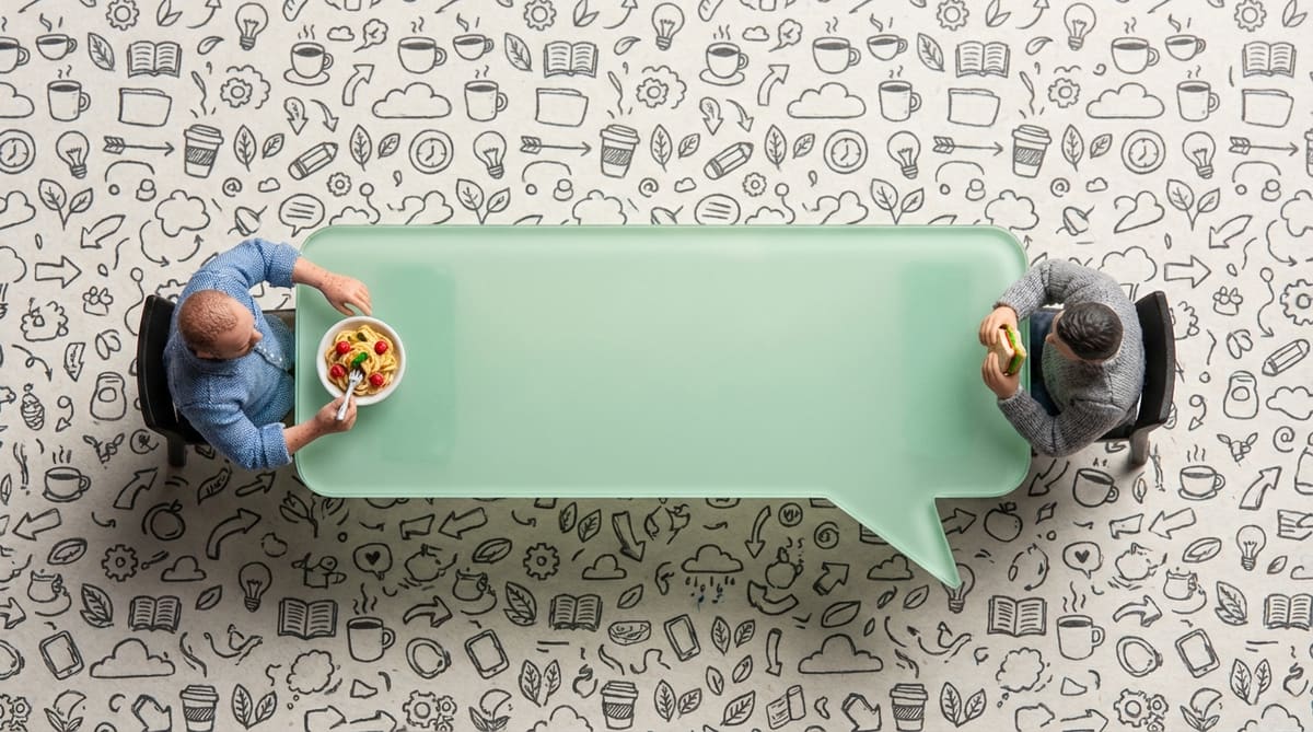 Tiny humans around a speech bubble table