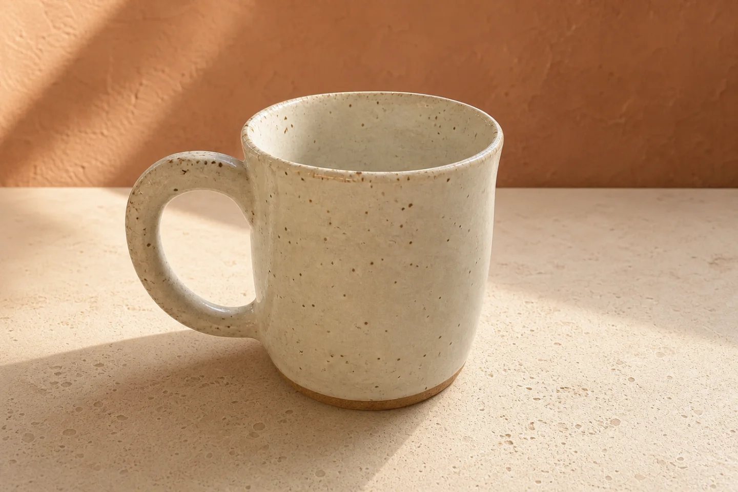 Edited ceramic mug photo with a clean terracotta studio background and warm directional light