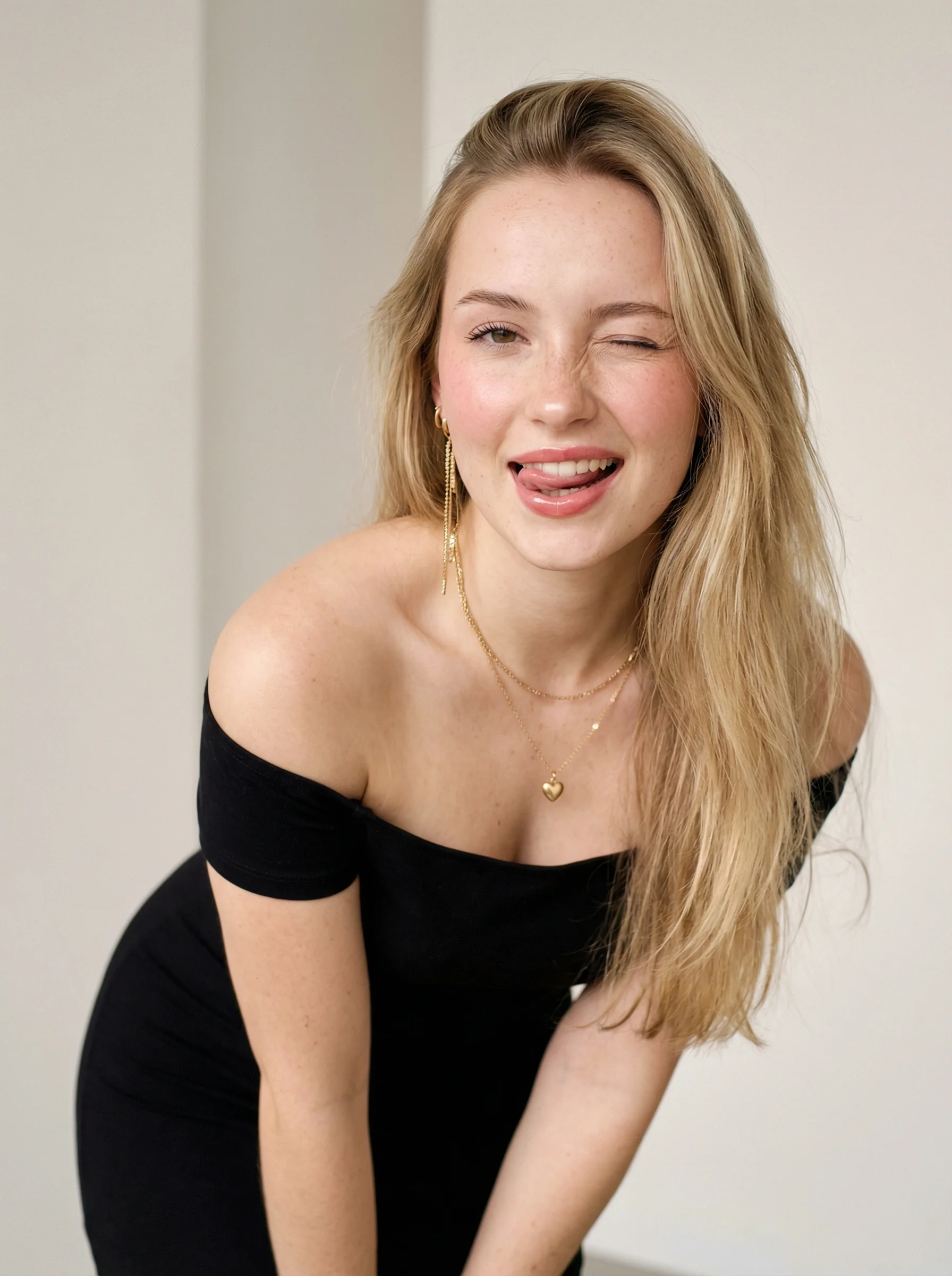 Ultra-realistic studio portrait of playful young woman winking with tongue out, blonde hair with freckles, black dress, gold earrings and necklaces, neutral background